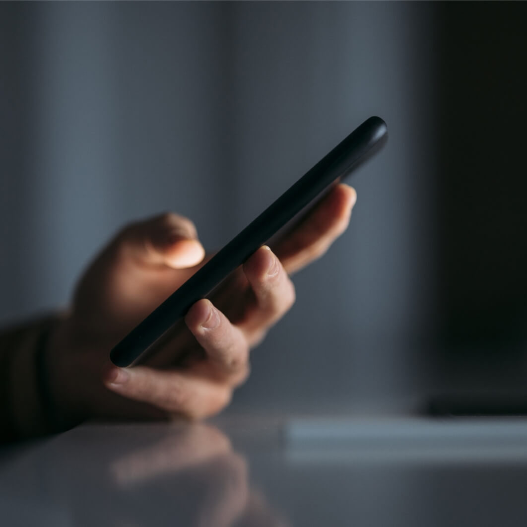 A person holding a cell phone in their hand.